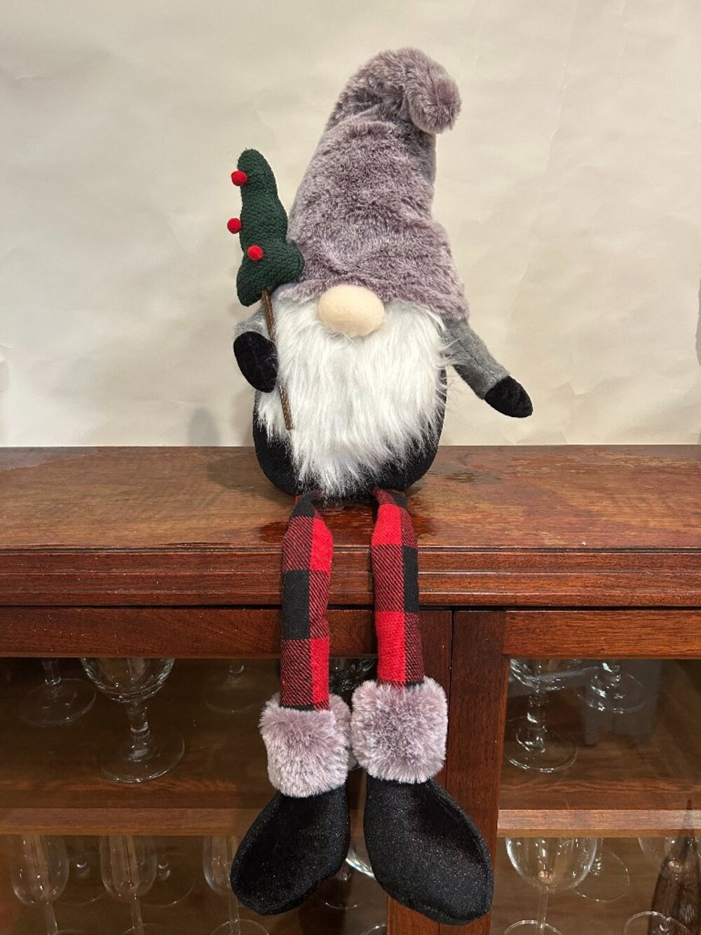 Christmas Holiday Gnome with gray cap and wispy white beard, holding tree